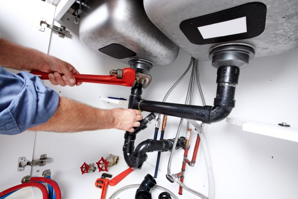 Woodstock Plumbing Pros fixing under sink plumbing and drain pipes