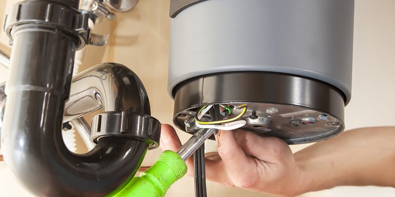 Woodstock, Georgia plumber servicing water heater pipe connection